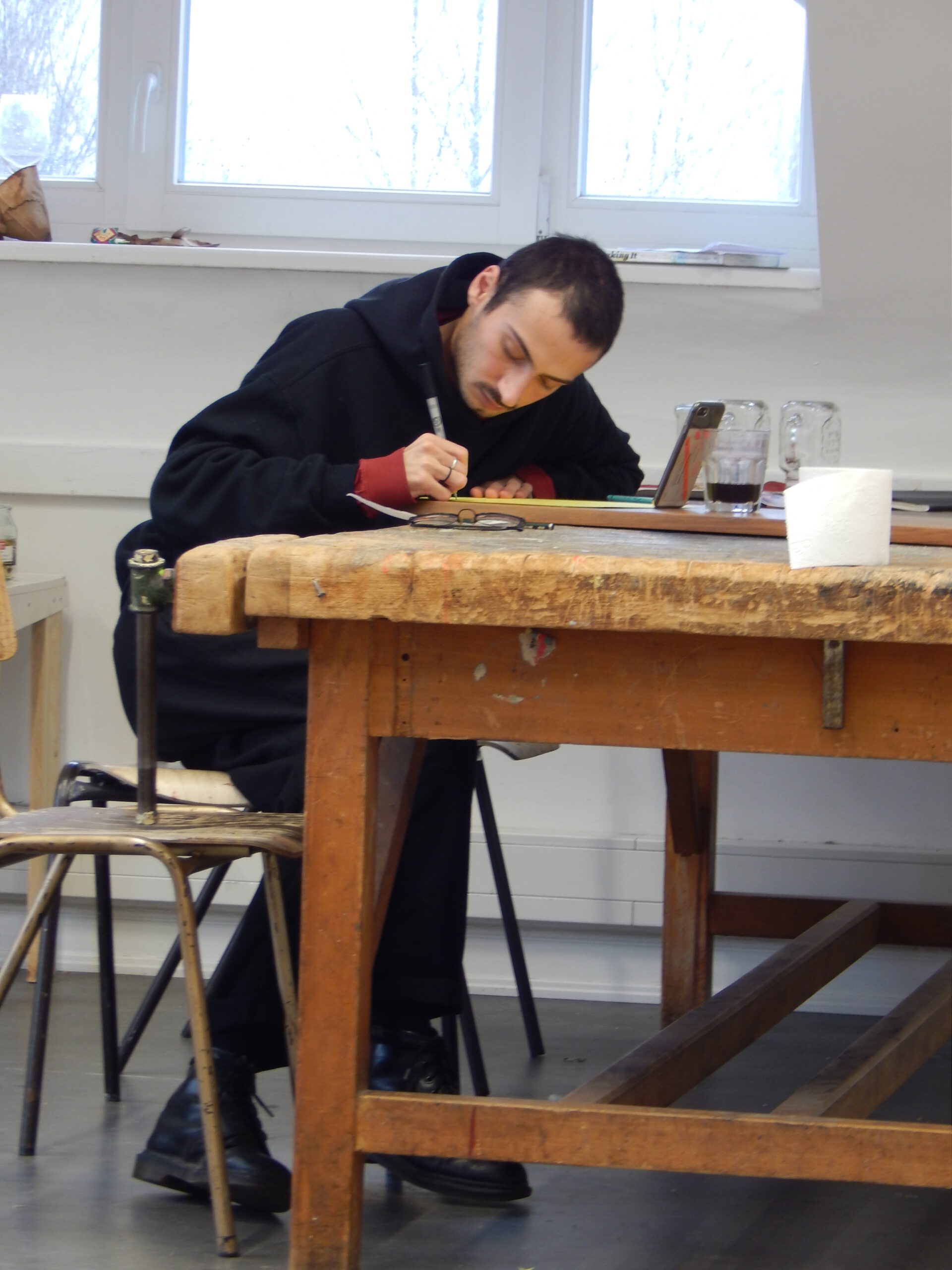 person writing during a workshop by artist Laura Mahnke